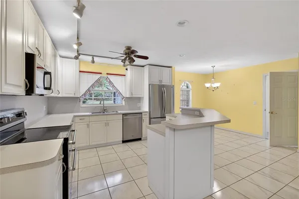 a kitchen with a sink appliances and cabinets
