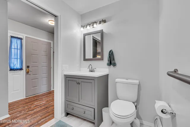 a bathroom with a toilet a sink and mirror
