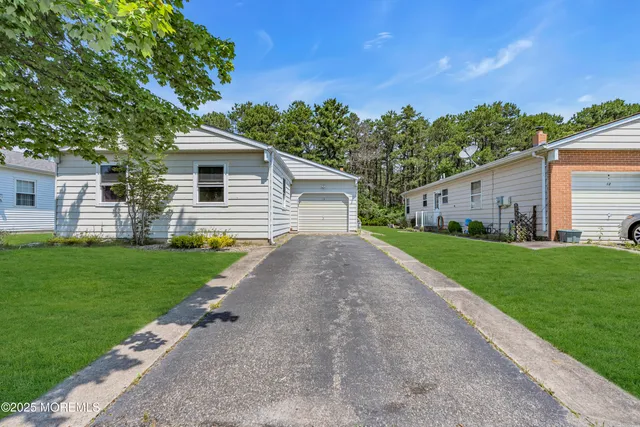 a front view of house with yard and green space