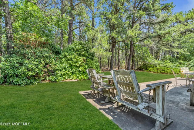 a view of a chairs and table in the garden