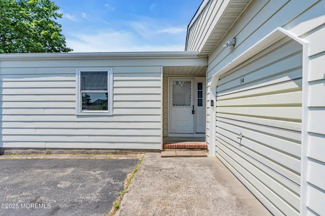 a view of a house with a white door and wooden floor