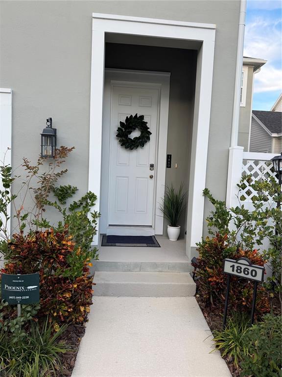a view of a front door and a potted plant