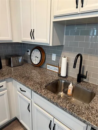 a kitchen with a sink and cabinets