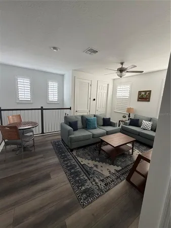 a living room with furniture wooden floor and window
