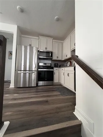 a kitchen with kitchen island a sink appliances and cabinets