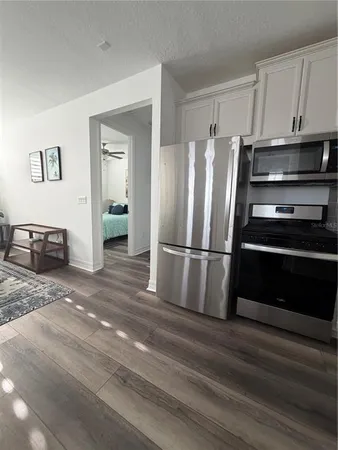 a kitchen with stainless steel appliances a refrigerator and a stove