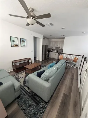 a living room with furniture and a rug