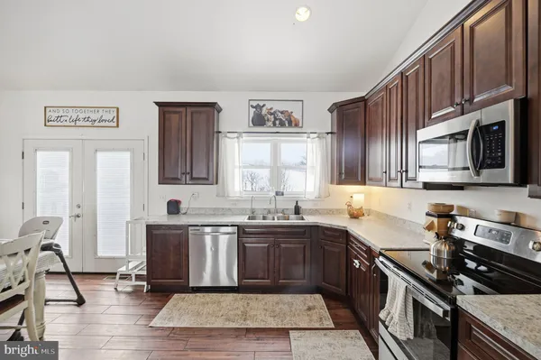 a kitchen with stainless steel appliances granite countertop a sink stove and cabinets