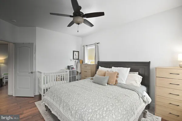 a bedroom with a large bed and a chandelier