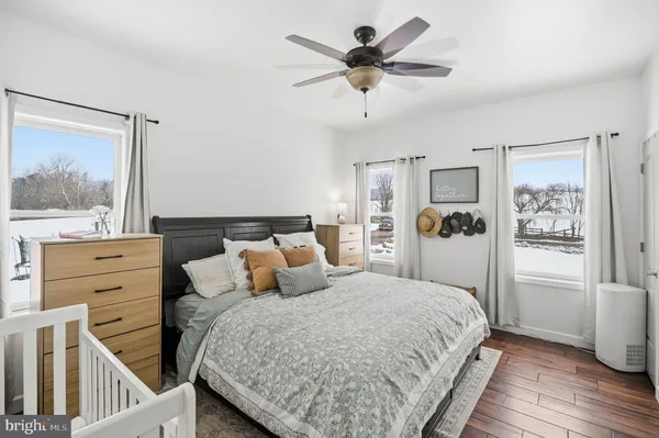 a bedroom with a large bed and a chandelier