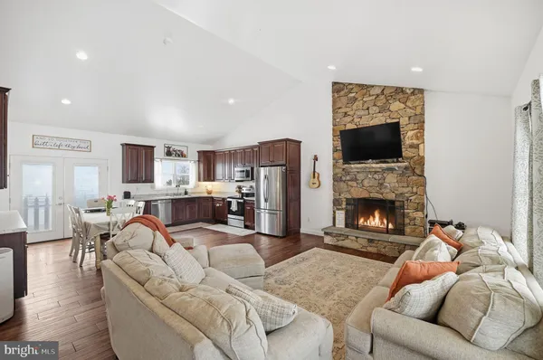 a living room with furniture fireplace and a flat screen tv