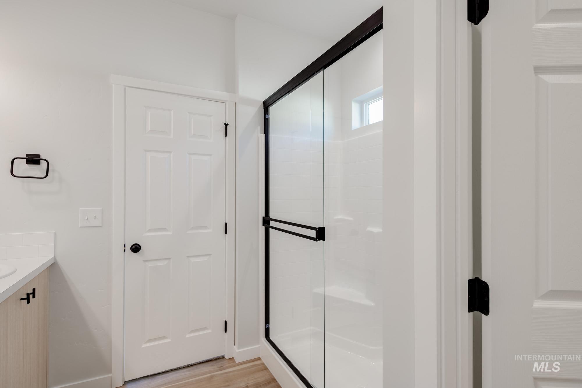 1634 Dyer Street Middleton, ID 83644 - Photo 20 of 25 Full bathroom featuring vanity, a shower stall, and light wood-type flooring