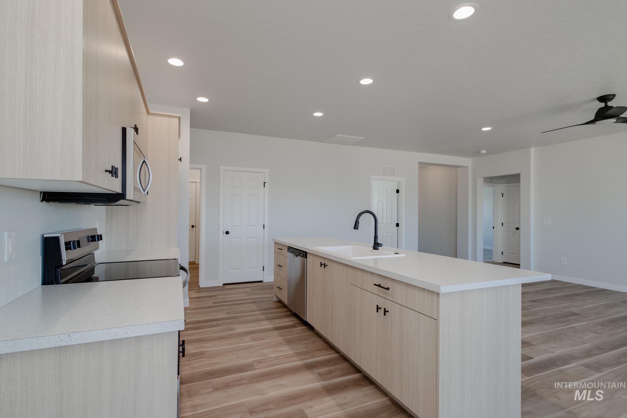 1634 Dyer Street Middleton, ID 83644 - Photo 5 of 25 Kitchen featuring light brown cabinetry, light countertops, light wood-style flooring, stainless steel appliances, and recessed lighting