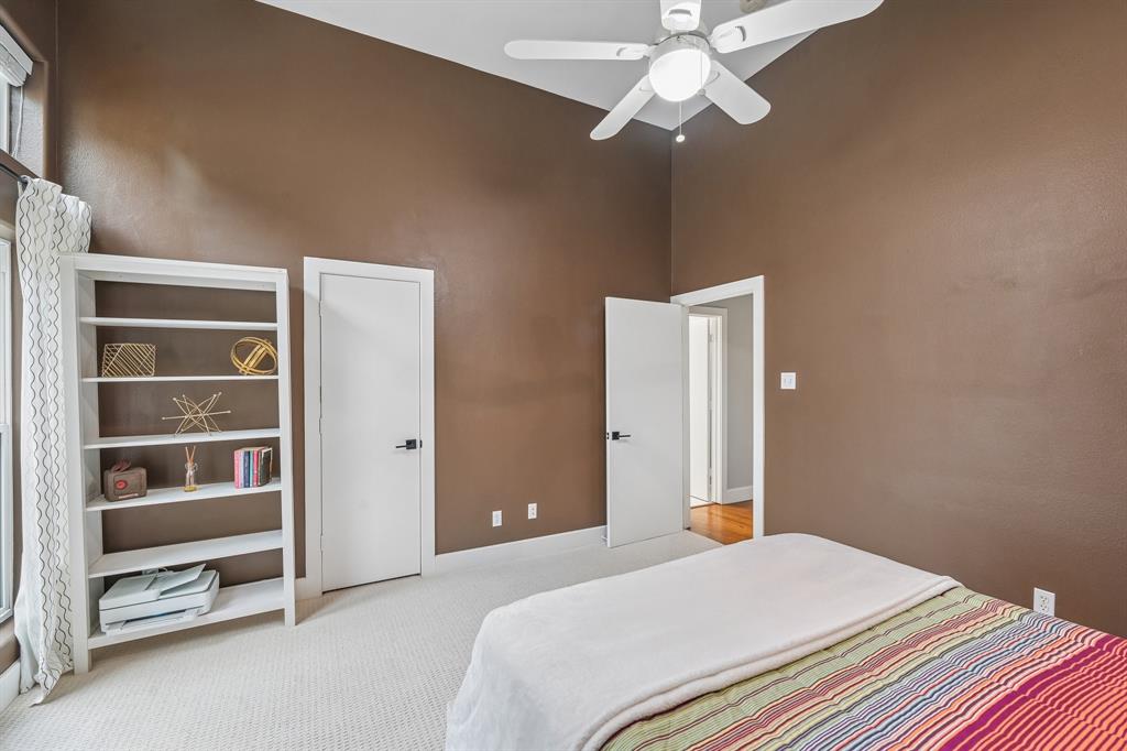 3553 Wheeler Street Dallas, TX 75209 - Photo 23 of 35 Secondary bedroom alternate view showing closet access, high ceilings, ceiling fan, and doorway to hardwood-floor hallway