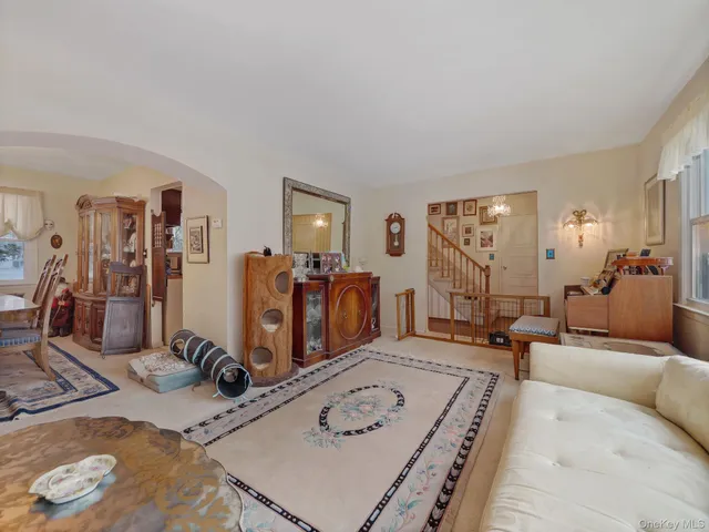 a dining room with furniture a chandelier and wooden floor