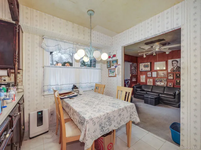 a kitchen with stainless steel appliances a sink a stove a refrigerator cabinets and living room view