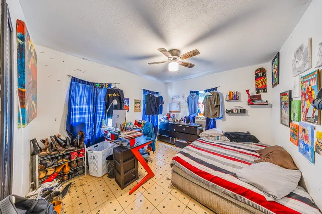a bedroom with bed and a chandelier