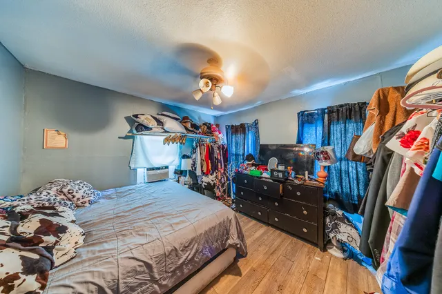 a bedroom with bed and a chandelier