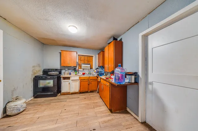 a kitchen with stainless steel appliances granite countertop a stove and a refrigerator