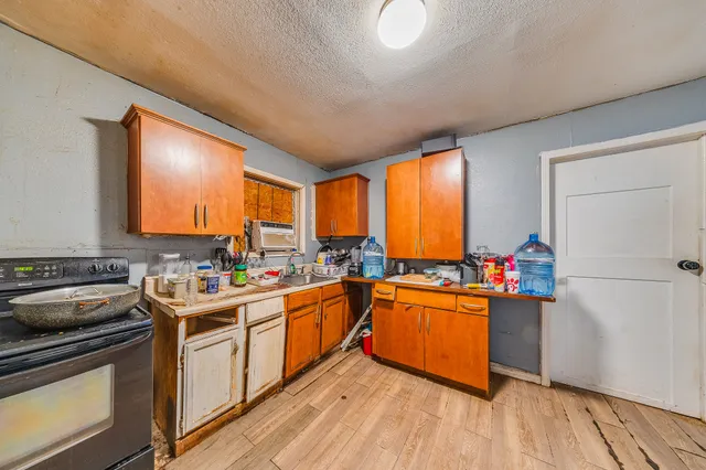 a kitchen with a stove a sink and a refrigerator