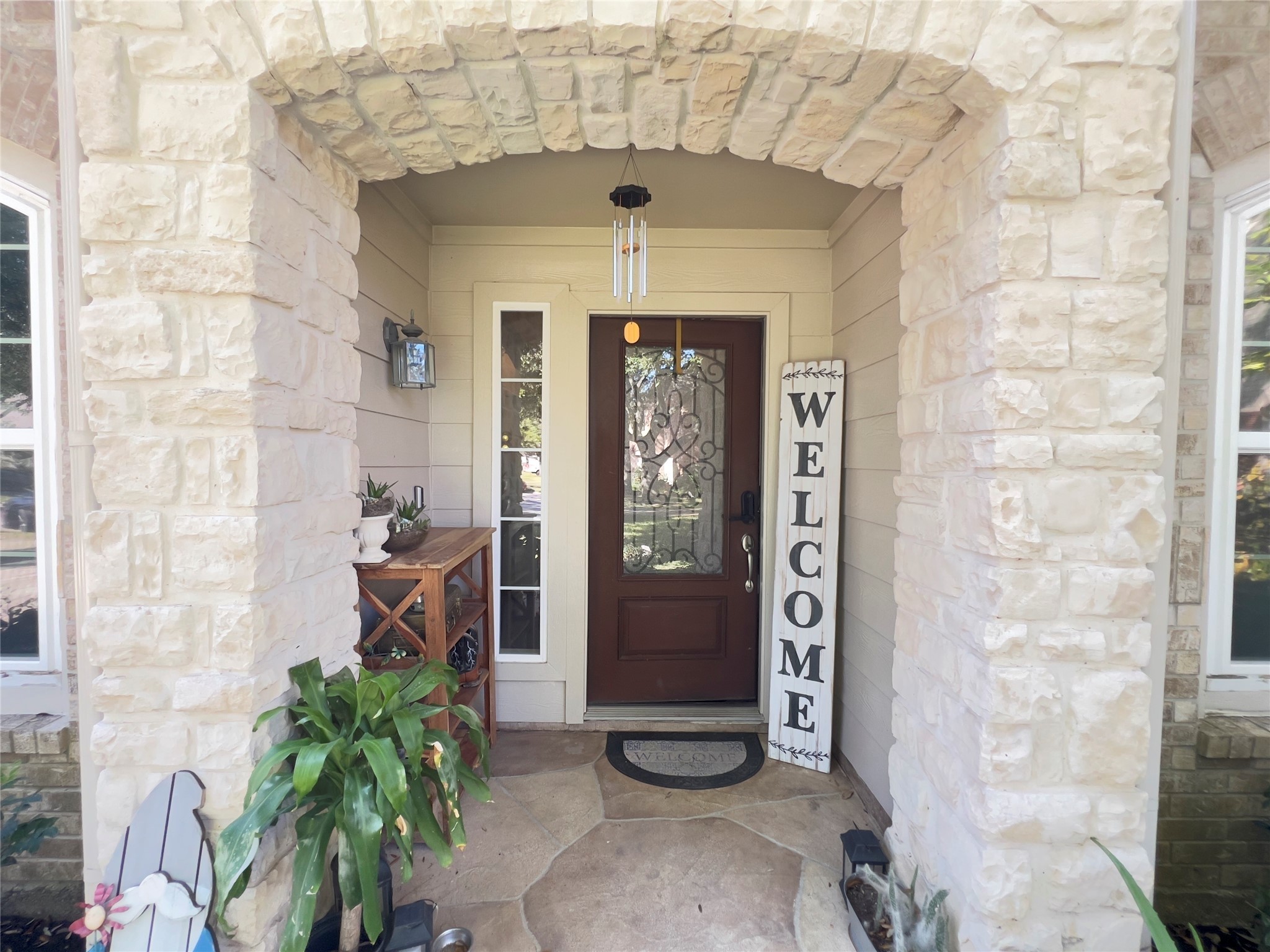 a view of a entryway door with potted plants