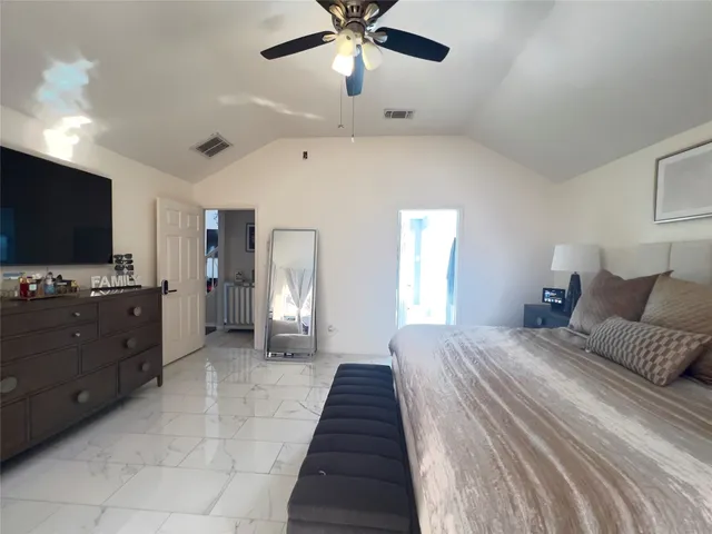 a spacious bathroom with a granite countertop sink mirror and shower