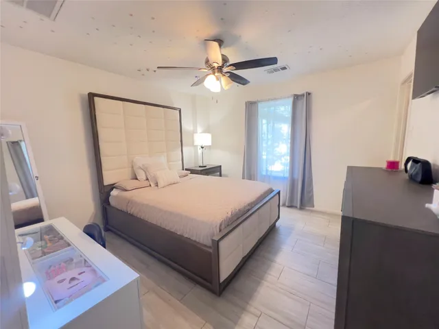 a bed room with a bed and a television