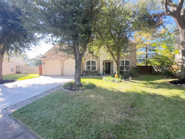 a view of yard with swimming pool and large trees