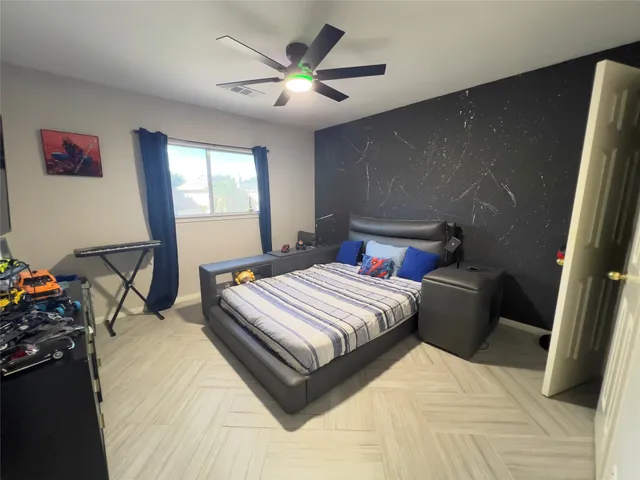 a bedroom with a bed and a chandelier