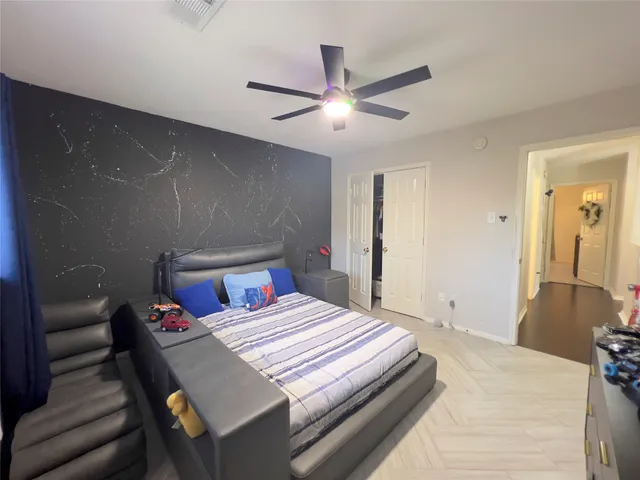 a large bed sitting in a bedroom next to a window