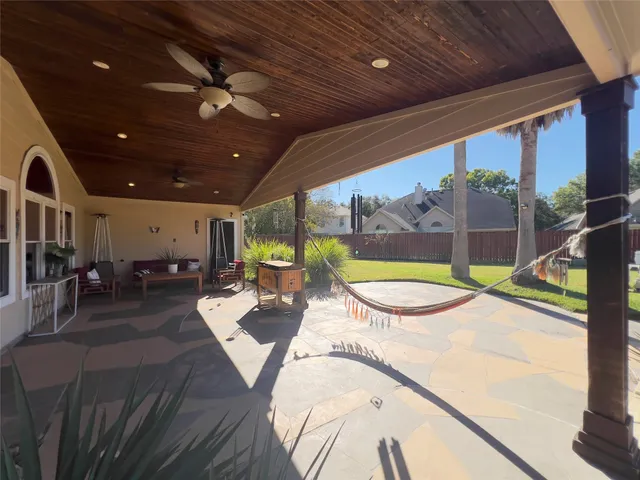 a view of a house with backyard porch and sitting area