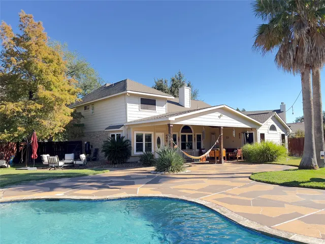 a view of a swimming pool with an outdoor space and seating area