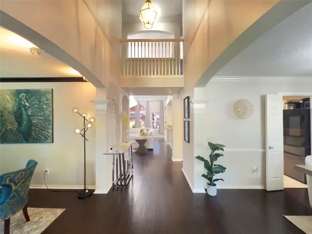 a view of an entryway with wooden floor and a livingroom