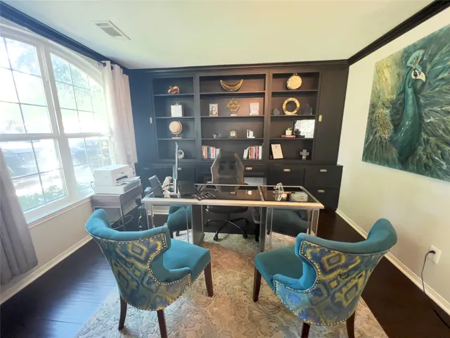 a living room with furniture and floor to ceiling window