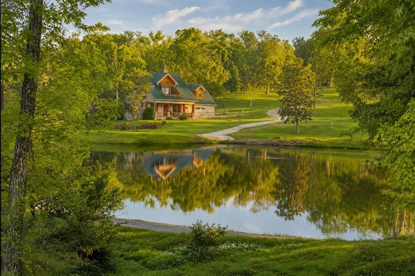 a view of a lake with a house in the background