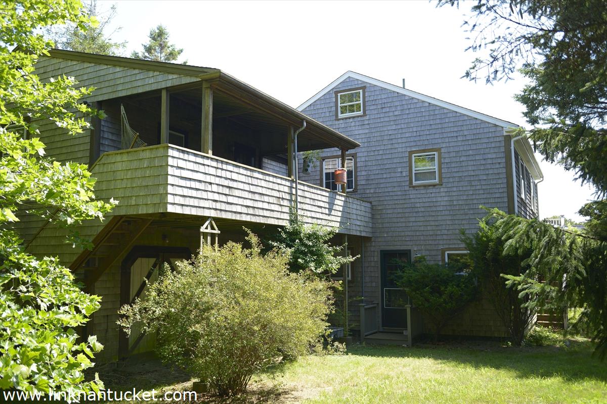 81 Fairgrounds Road Nantucket, MA 02554 - Photo 2 of 6 a front view of a house with a yard