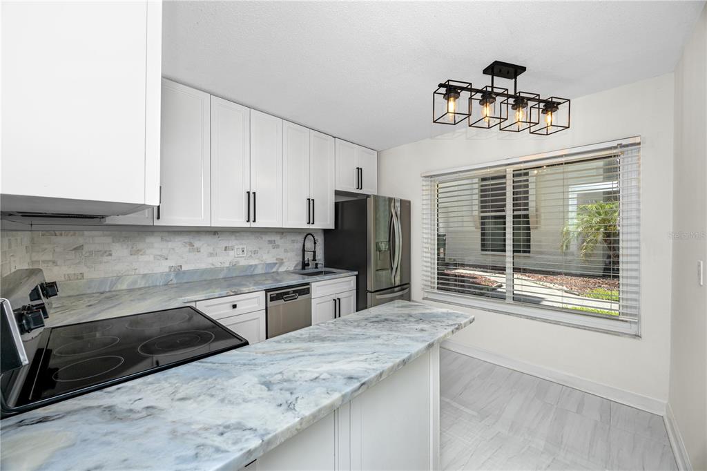 2207 Belleair Road, Unit B4 Clearwater, FL 33764 - Photo 25 of 37 a kitchen with stainless steel appliances granite countertop a sink stove and refrigerator