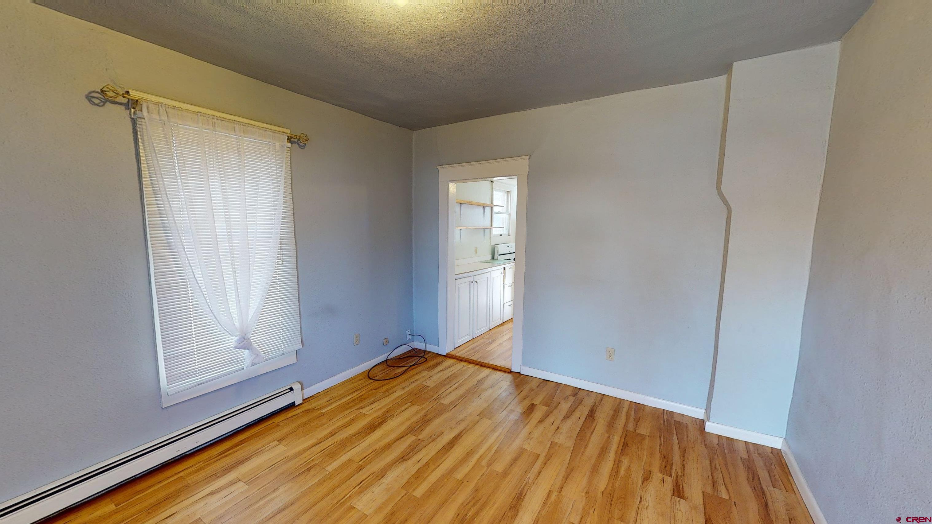 1016 Lincoln Avenue Alamosa, CO 81101 - Photo 2 of 10 a view of empty room with wooden floor