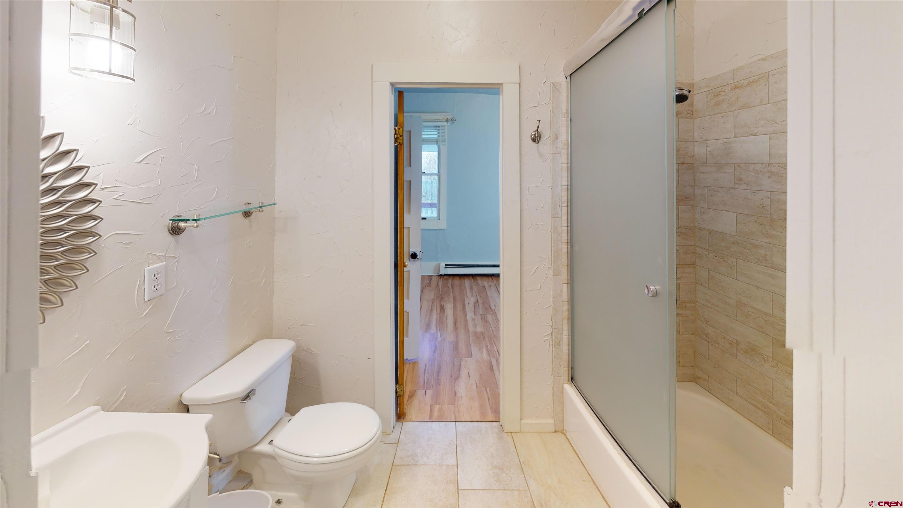 1016 Lincoln Avenue Alamosa, CO 81101 - Photo 7 of 10 a bathroom with a toilet and a shower