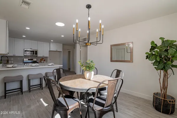 a view of a dining room with furniture and wooden floor