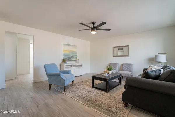 a living room with furniture and a wooden floor