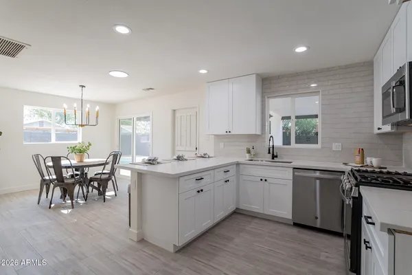 a kitchen with a sink and stove top oven