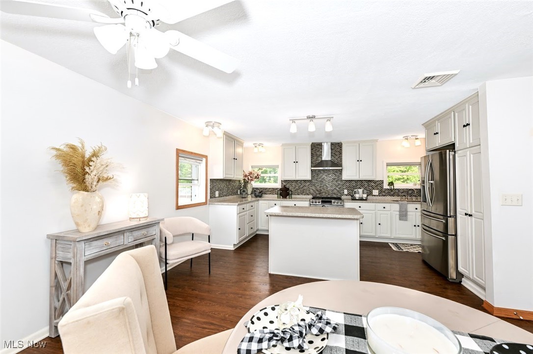 4597 Rock Cut Road Barberton, OH 44203 - Photo 14 of 44 *DINING AREA EAT IN KITCHEN IS LARGE ENOUGH FOR A 6-8 SEATER TABLE WITH DUAL FANS, LIGHTING AND LUXURY PLANK FLOORING - NEAR BREAKFAST BAR/ISLAND