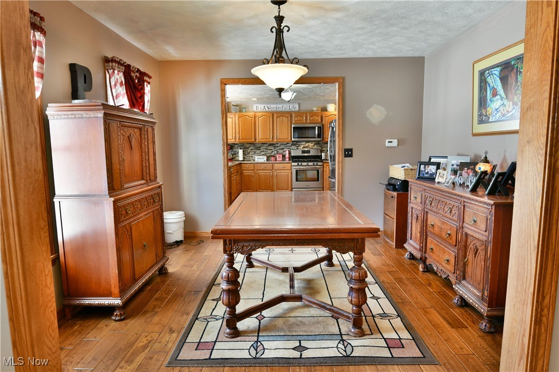 5915 Downs Road Northwest Warren, OH 44481 - Photo 3 of 50 Dining area with light hardwood / wood-style flooring and a textured ceiling
