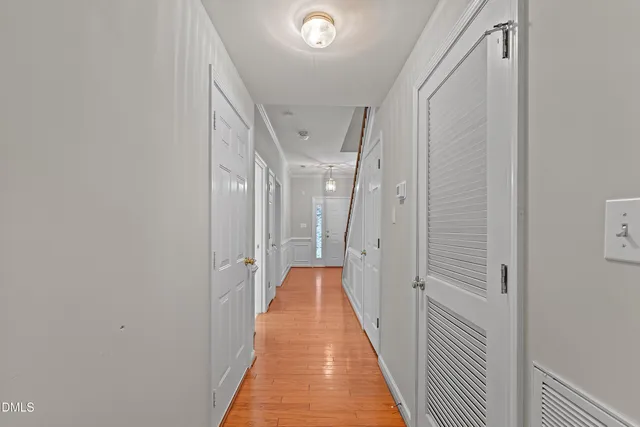 a view of a hallway with wooden floor and staircase