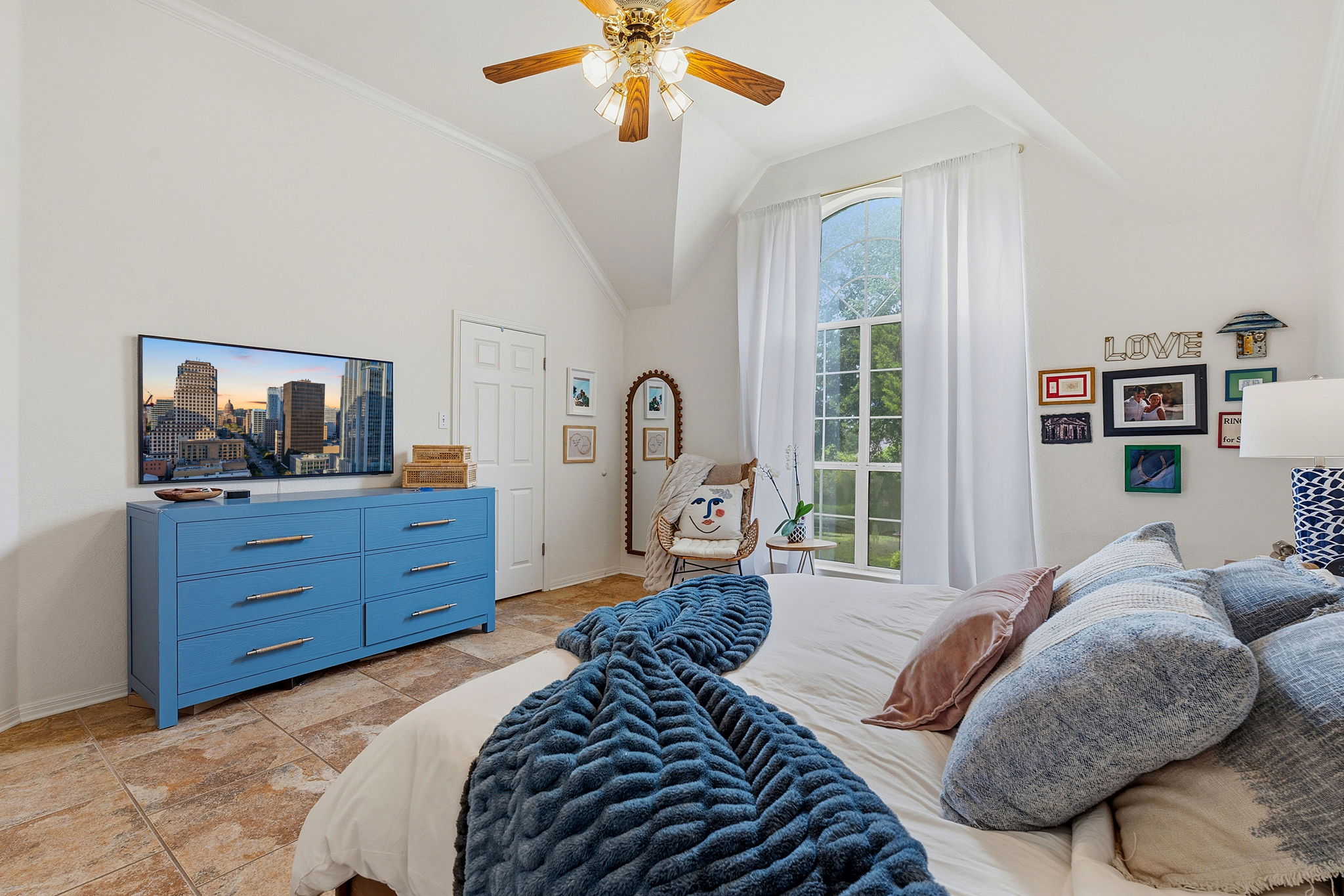 8317 Pommel Drive Austin, TX 78759 - Photo 17 of 26 Natural light streams into this bedroom through an arched window, creating a serene and airy retreat.