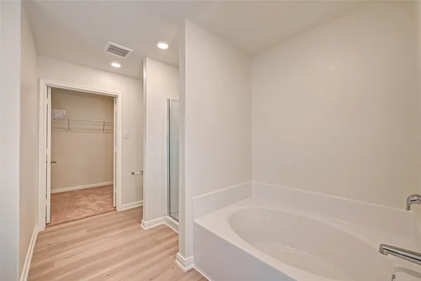 a bathroom with a bathtub and shower