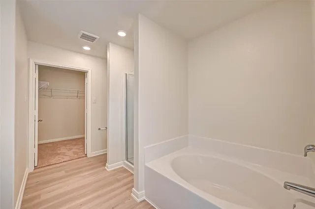 a bathroom with a bathtub and shower