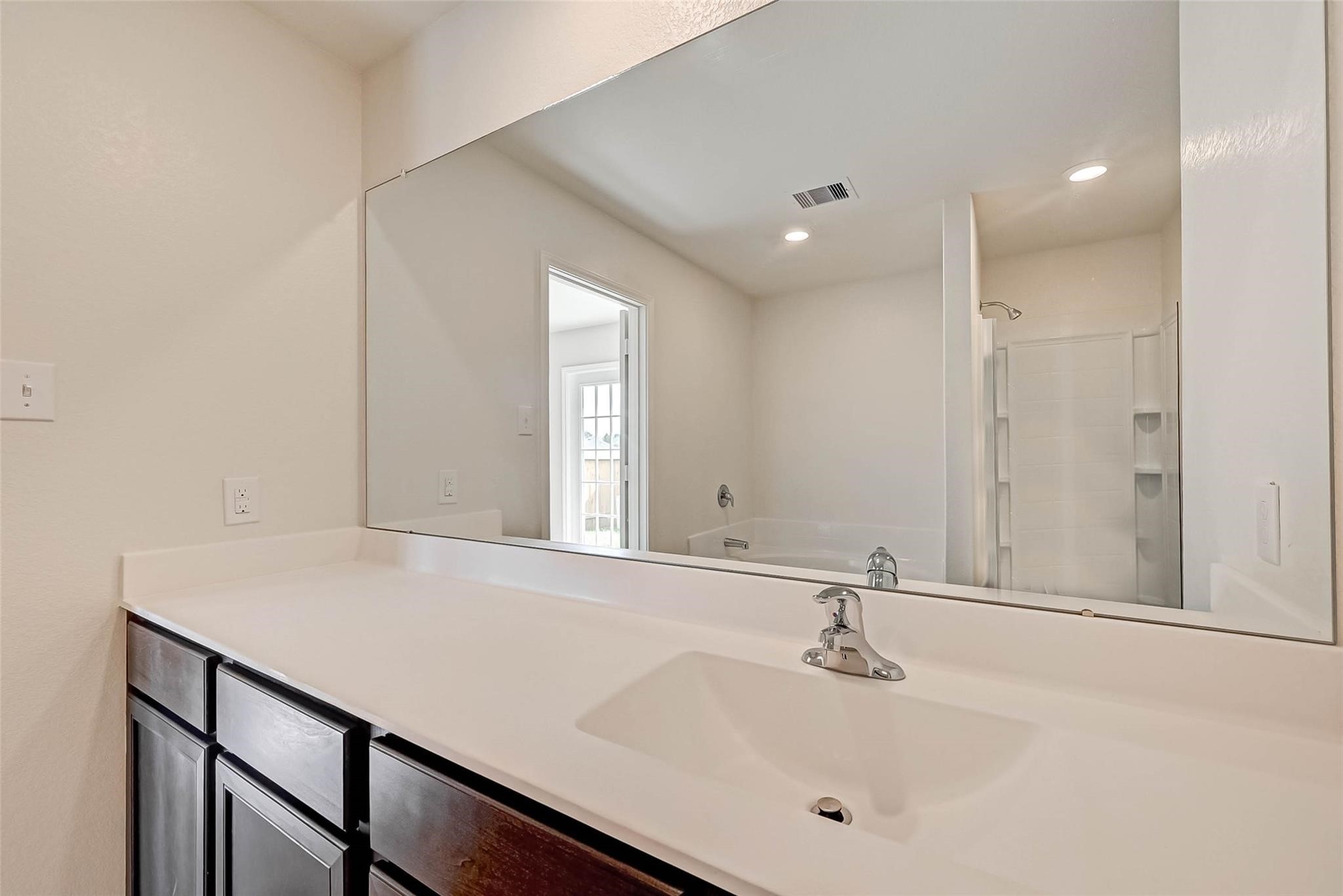 20834 Solstice Point Drive Hockley, TX 77447 - Photo 14 of 16 a bathroom with a sink and a mirror
