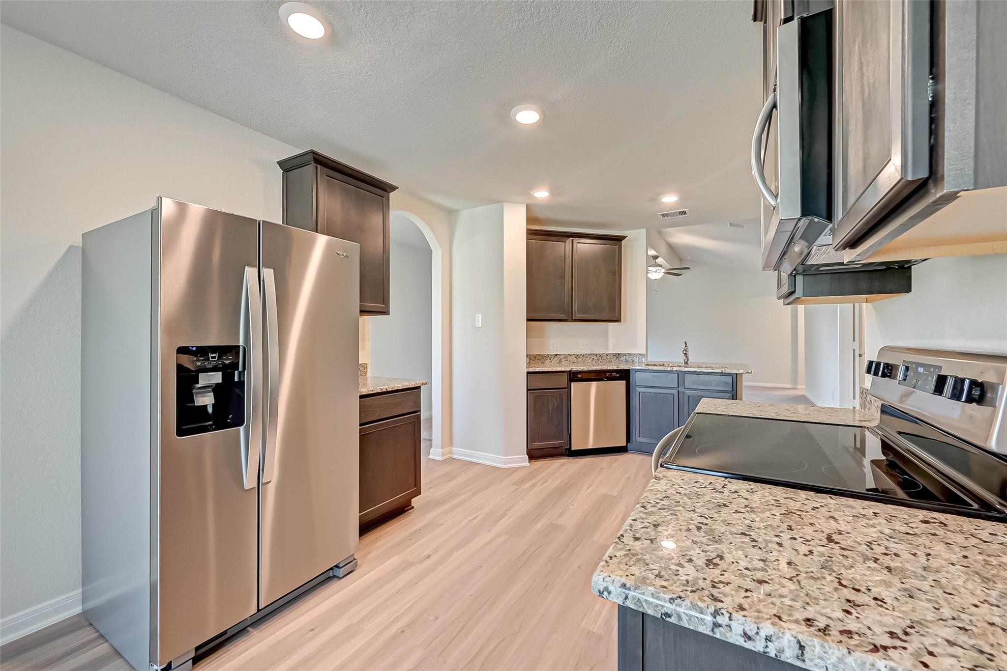 20834 Solstice Point Drive Hockley, TX 77447 - Photo 4 of 16 a kitchen with stainless steel appliances granite countertop a refrigerator stove and oven